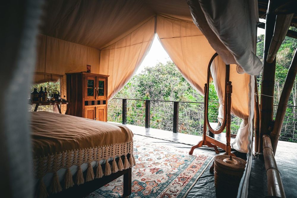 Inside a canvas safari tent at Desa Eko, open to the valley